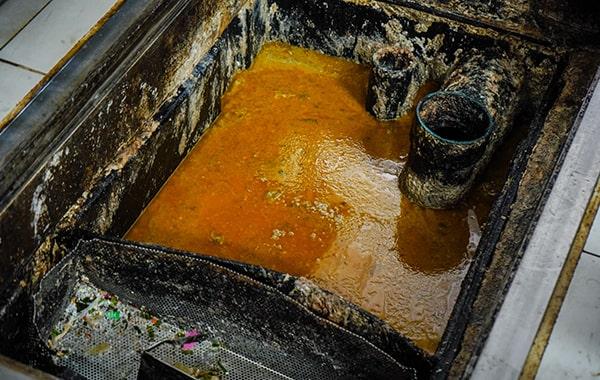 procrastinating on grease trap cleaning can result in clogs, foul odors, and even sewage backups